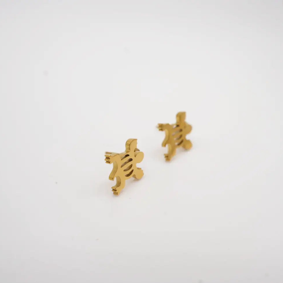 Gold adinkra earrings on a white background