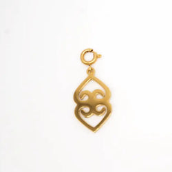 Gold pendant with intricate design on a white background - mother earth charm from adinkra symbols. Asase Ye Duru