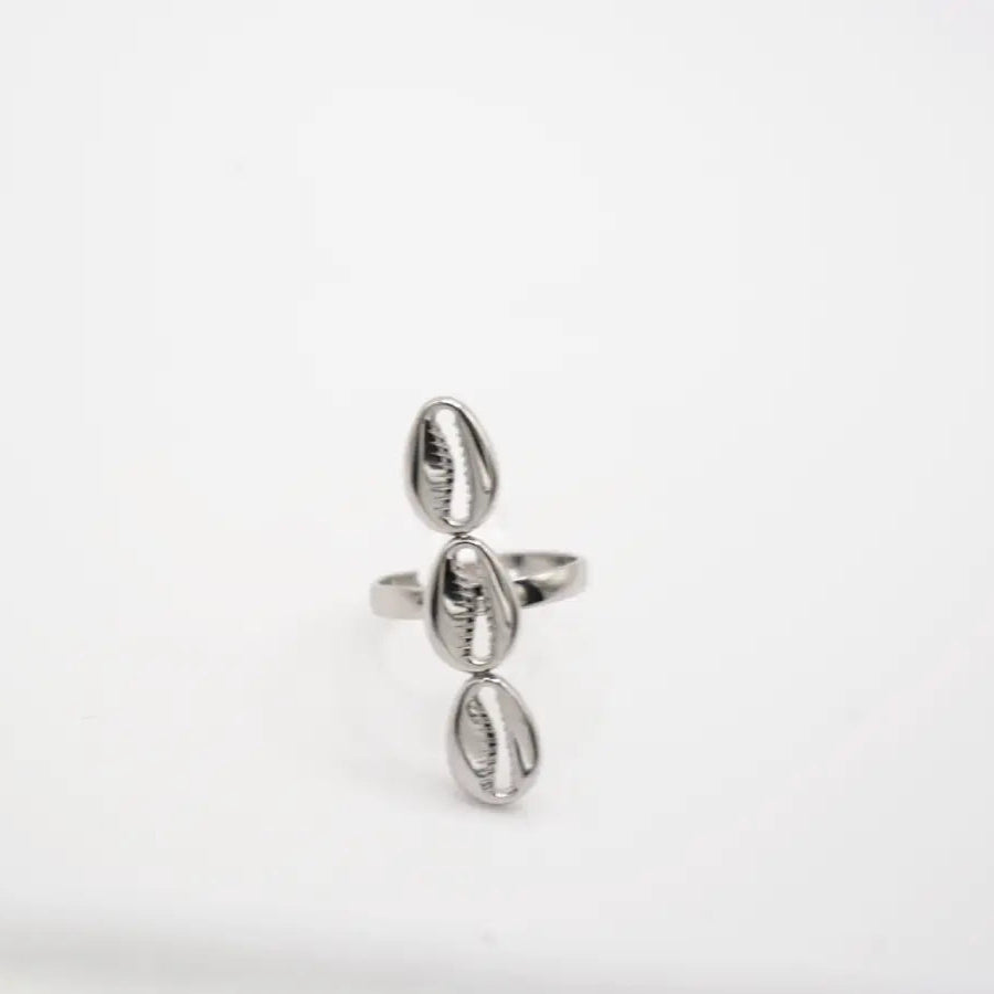 Silver cowry ring with a unique design on a white background