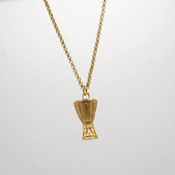 Gold necklace with a unique  Djembe pendant on a light gray background. African drum necklace 