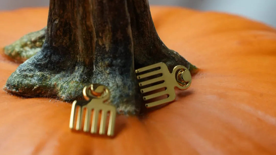 Gold earrings on a pumpkin