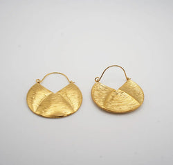 Pair of gold earrings on a light gray background