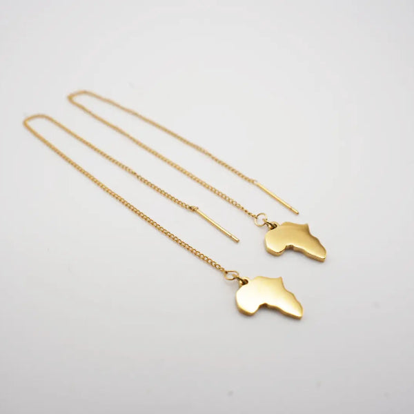 Two gold necklaces with africa map shaped pendants on a light gray background