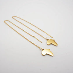 Two gold necklaces with africa map shaped pendants on a light gray background