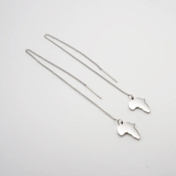 Silver necklace with africa continent map pendants on a light gray background