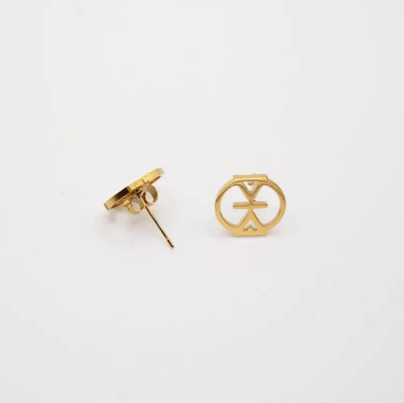 Gold Resilience stud earrings with a unique design inspired by Mmere Dan adinkra symbleon a white background