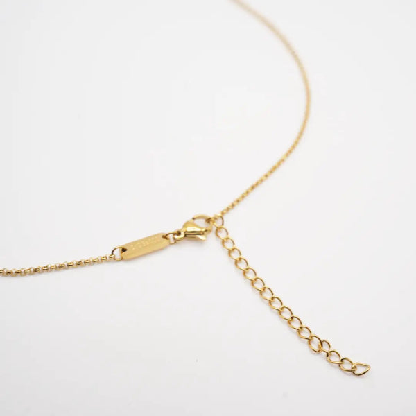 Gold chain necklace on a white background