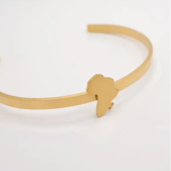 Gold bracelet with a unique african map design on a white background