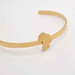 Gold bracelet with a unique african map design on a white background