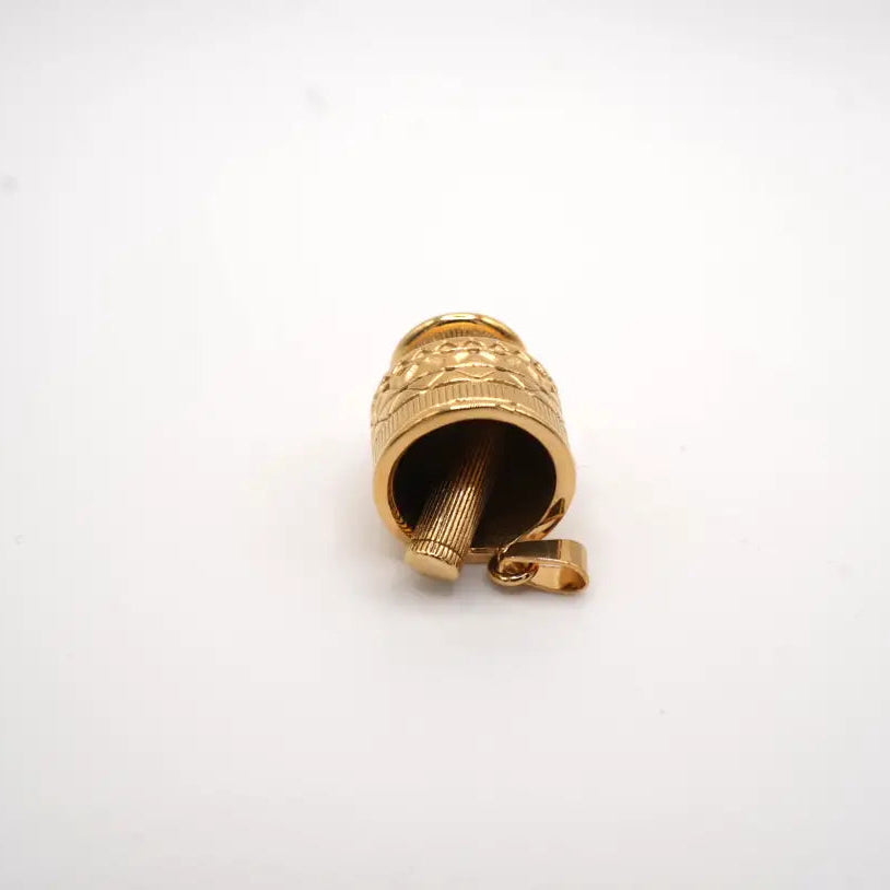 Gold-colored valve stem cap on a white background