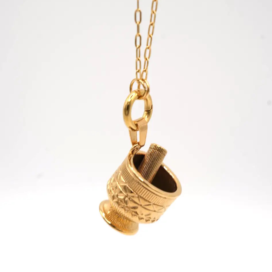 Gold pendant necklace on a white background