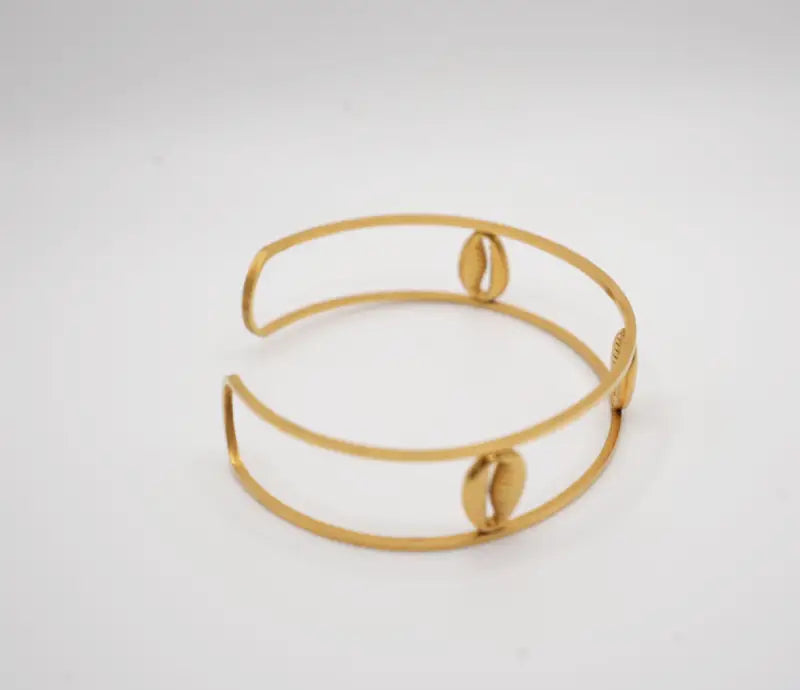 Gold bracelet on a light gray background