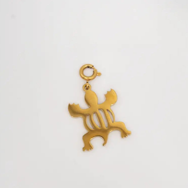 Gold crocodile-shaped pendant on a white background