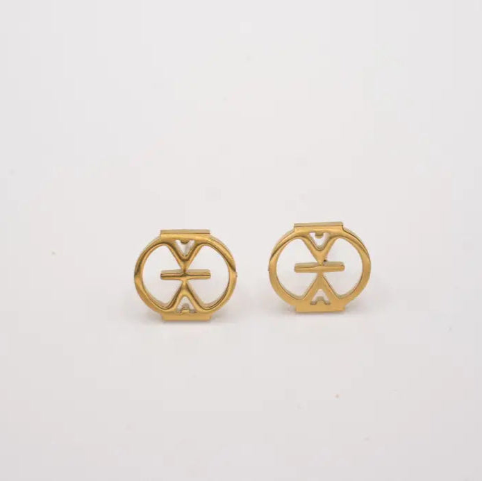 Pair of gold earrings with circular designs on a white background. Adinkra studs that means resilience