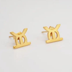 Gold earrings with a unique design on a light gray background
