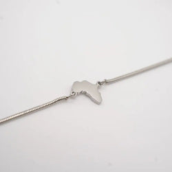 Silver bracelet with a small pendant on a light gray background