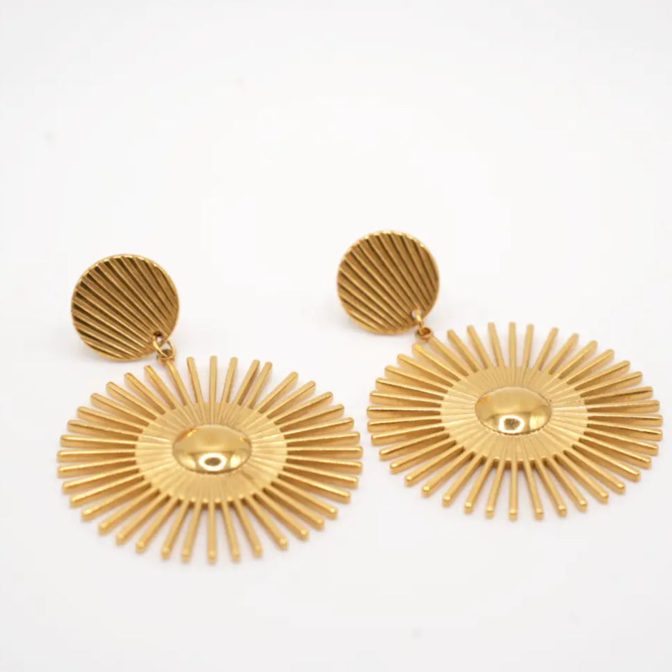 Pair of gold earrings on a white background - Tilo La Earrings - sun earrings